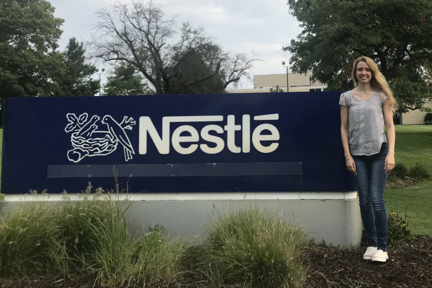 Emily Principe in front of Nestle Corporation sign