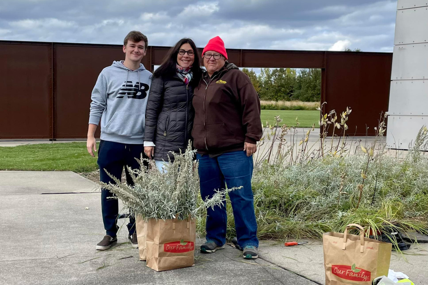Skyler Wolverton, Dr. Dee Sherwood and Laura Moss stand with a harvest of sage and sweet grass.