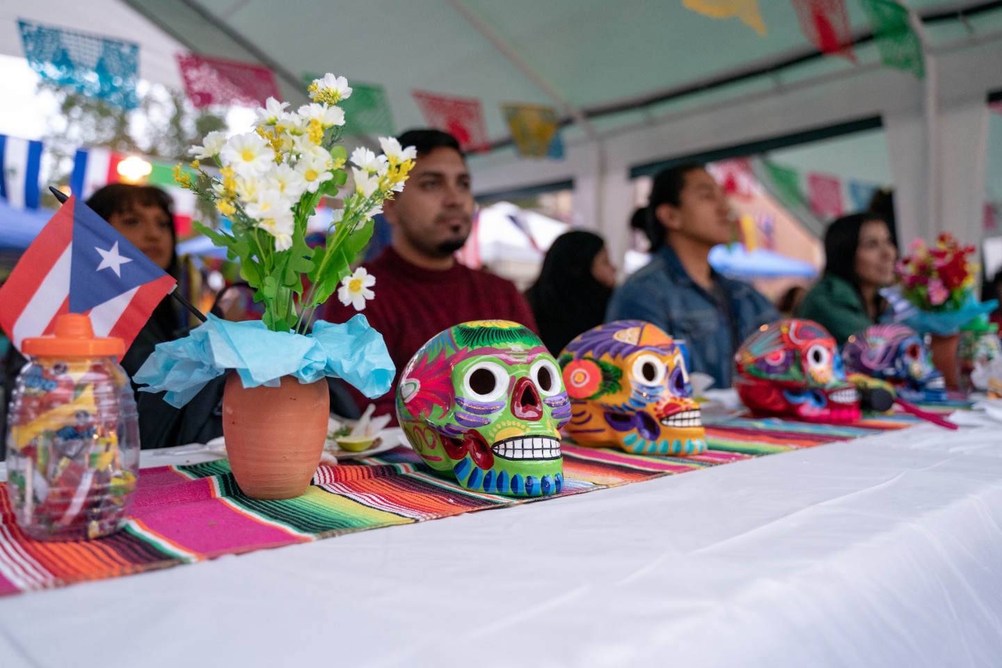 Colorful skulls are lined up on a table for a Hispanic Heritage Month celebration.