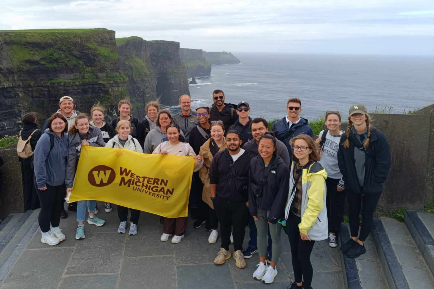 Students in Ireland holding the WMU flag