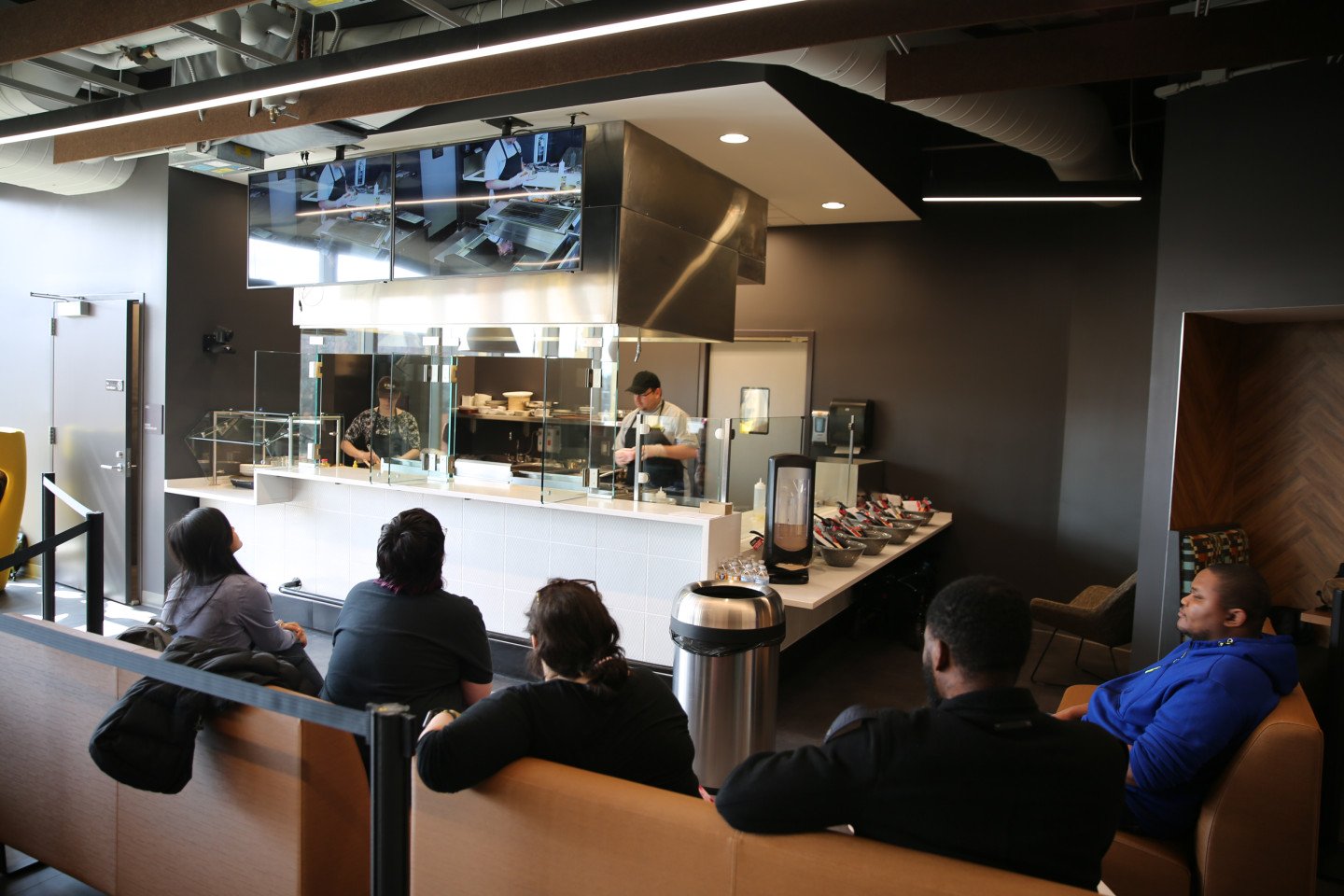 Chef Francisco cooking a quesadilla in the demo kitchen in the WMU Student Center with students watching.
