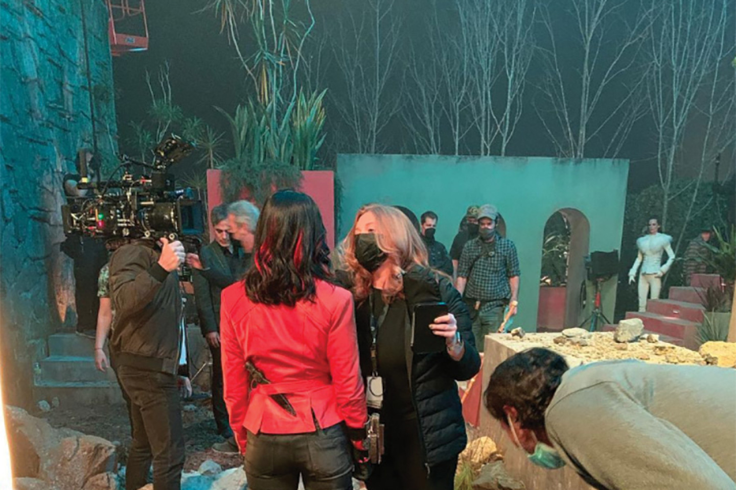 Ellen Arden applies makeup to an actress on set.