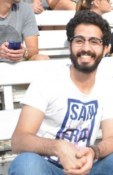 Ahmed Alashi sitting on bleachers