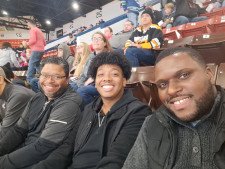 Mentor, mentee, and staff in the Community Mentoring Program at a basketball game.