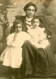 A black and white family photo of Merze Tate as a child.