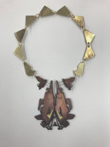 A necklace fashioned from gold and copper metals.