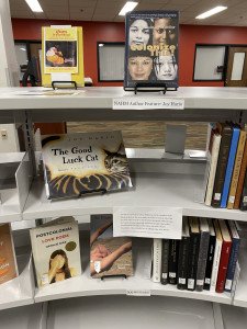 Books are displayed on a shelf.