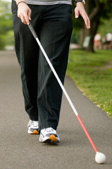 Photo of man using a long cane.