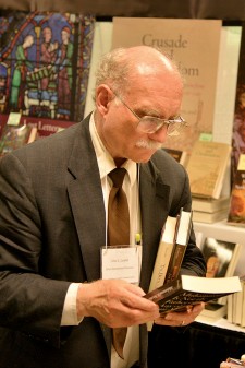 Photo of an attendee looking at books.