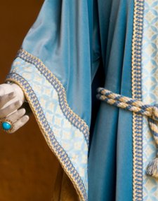 A blue, gold, and white medieval dress on a mannequin