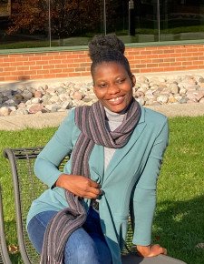 Photo of Hellen Yaa Agbevey outside in the courtyard of Schneider Hall