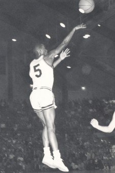 A young Manny Newsome shoots a basketball.