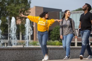 Three students walking in front of Miller Fountain.