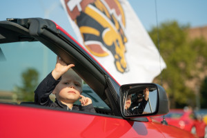 A child sits in a convertible.