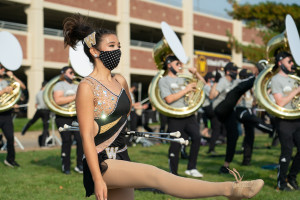 A Bronco Marching Band twirler holds her batons.