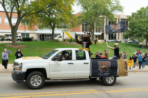 Buster Bronco rides in a truck during the parade.