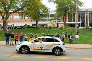 The College of Engineering and Applied Sciences' car drives down the parade route.