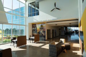 The main entry of the Aviation Education Center, featuring seating and a propeller on a wall.