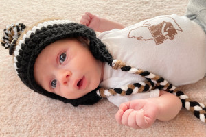 A baby wearing a winter hat.