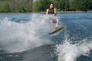 A person jumps out of the water on a wakeboard.