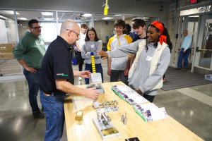 An instructor shows an experiment to students in the AMP Lab.