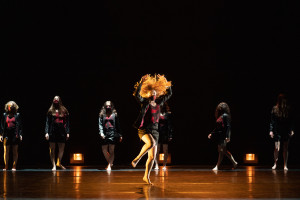 Dancers perform on stage.