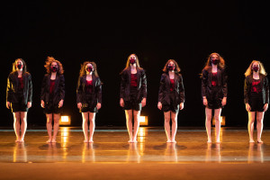 Dancers in a line on stage.