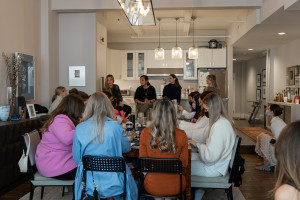 A group of women eat brunch in an apartment.