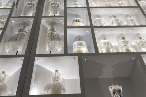 A wall full of white dresses.