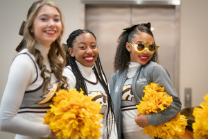 Cheerleaders pose for a picture.