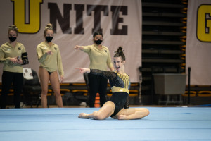 Payton Murphy points a finger during a gymnastics routine.