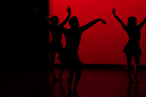 Silhouettes of dancers on stage.