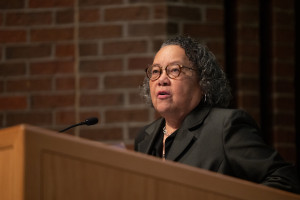 Dr. Barbara Savage speaks at a podium.