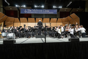 An orchestra plays on the stage.
