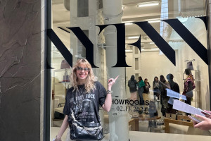 Laura Argentati points to a window with NYFW written on it.