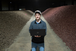 Skyler Thompson holds his laptop.