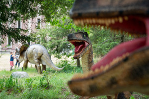 Dinosaur statues on the grass near Rood Hall.