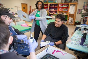 Alexis Bailey and Steven Lopez work with participants from the Center for Disability Services