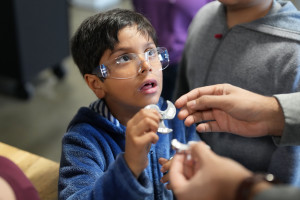 Boy with safety goggle holding a fidget spinner