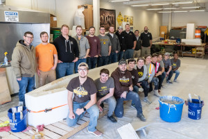 The WMU concrete canoe team poses with the mold for its recent canoe.