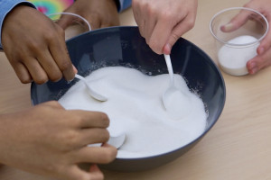 Scooping sugar from bowl