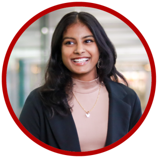 Human resource management major Ambika Burramukku is wearing a tan shirt and black blazer.