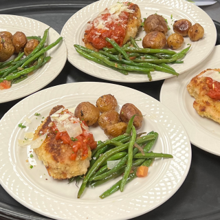 Plated chicken breast with green beans and new potatoes
