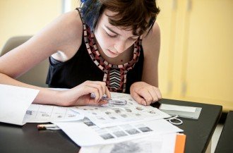 Young woman looking at fingerprint cards