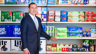 Michael Doss stands in front of packaged groceries