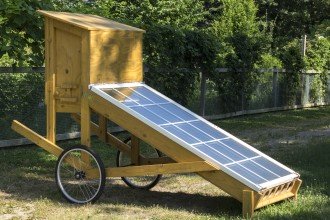 solar panels attached to a wooden rig with a chamber to dry foods