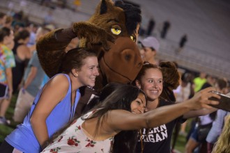 students taking a seflie with Buster Bronco.