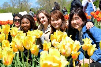 International students in a field of tulips.