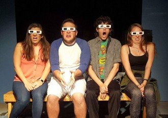 Jonathan Mammel in improv show with three other people sitting in a row with 3D glasses on, reacting in horror. 
