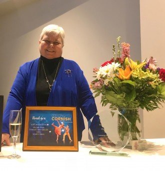 Wendy Cornish at table with award.